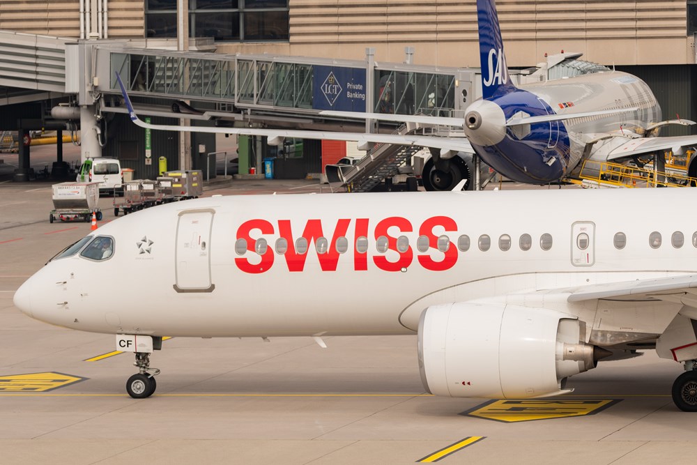 Swiss Airbus A220 with SAS aircraft in background